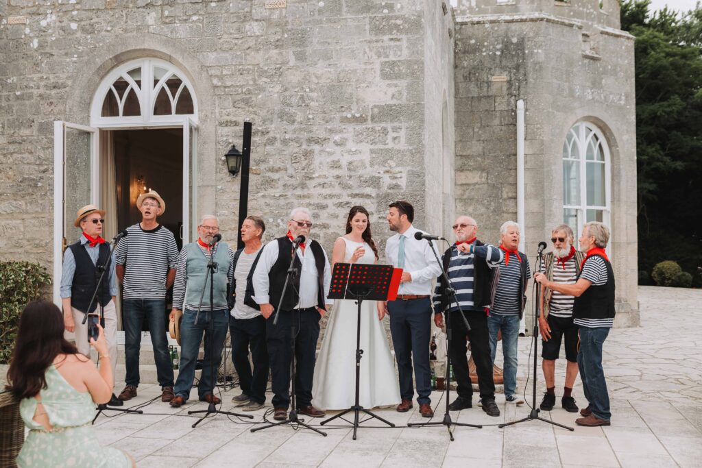 bride and groom singing with sea shanty band