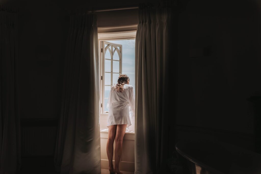 bride in pyjamas looking out of window
