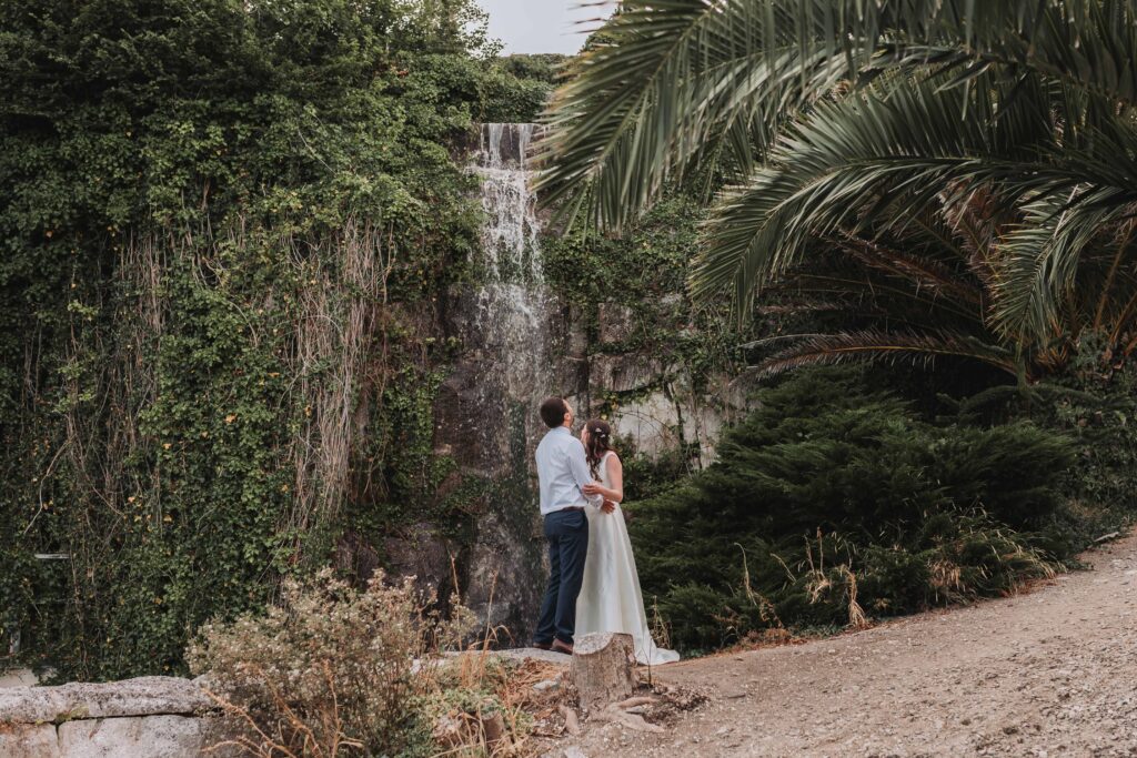 bride and groom at pennsylvania castle estate waterfall