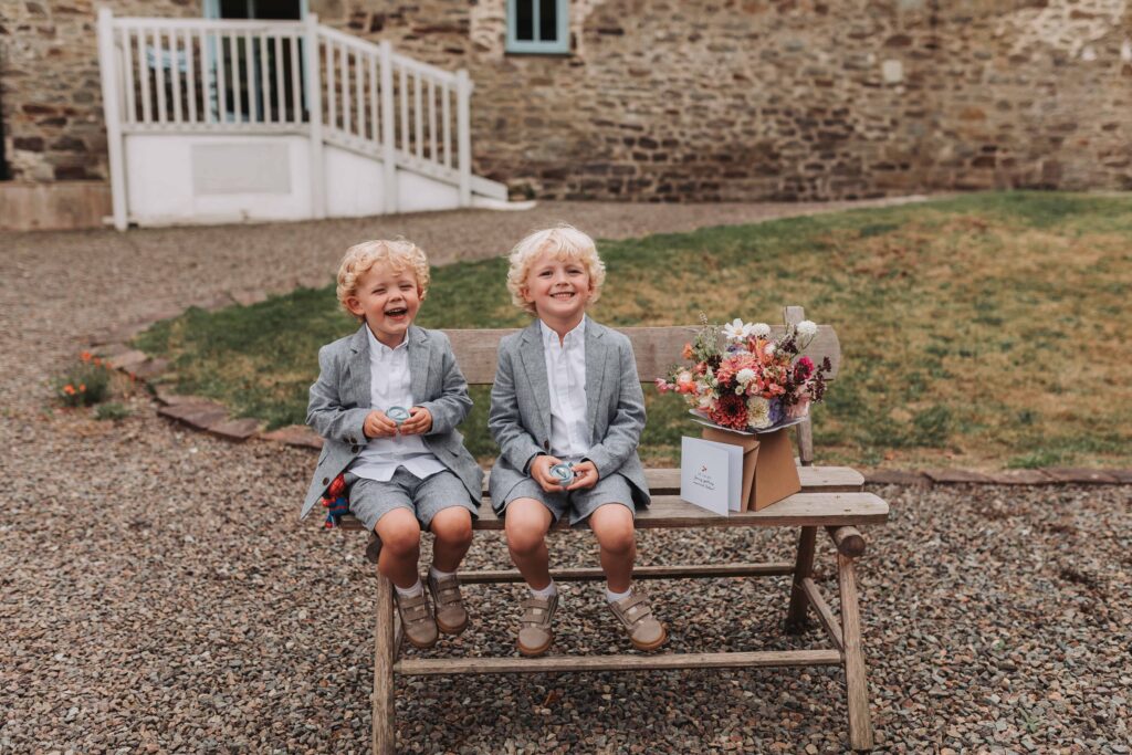 two young boys holding parents wedding rings
