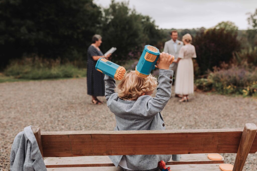son with bubble guns at countryside elopement