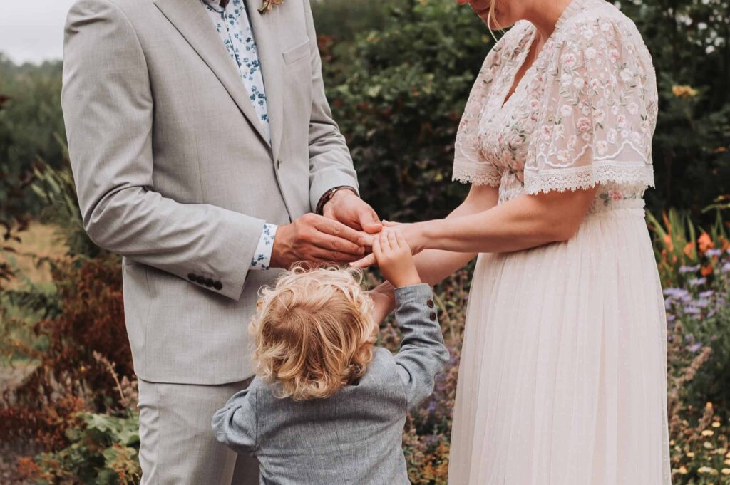 son helping dad put mums wedding ring on