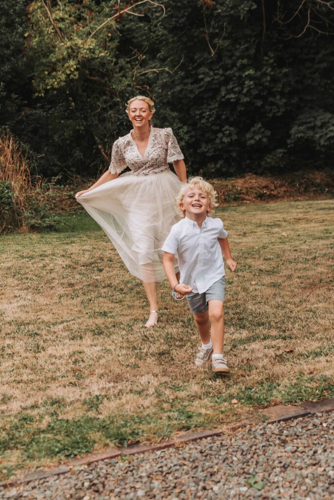 bride chasing son through the grass at countryside elopement