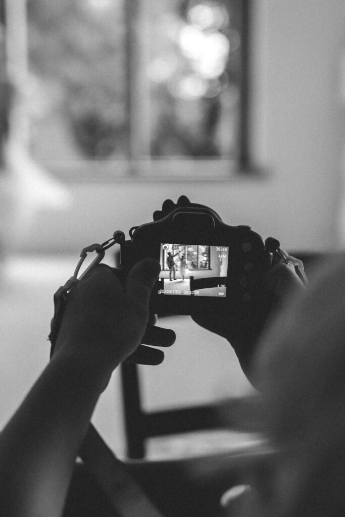 young son taking photo of his mum and dad dancing