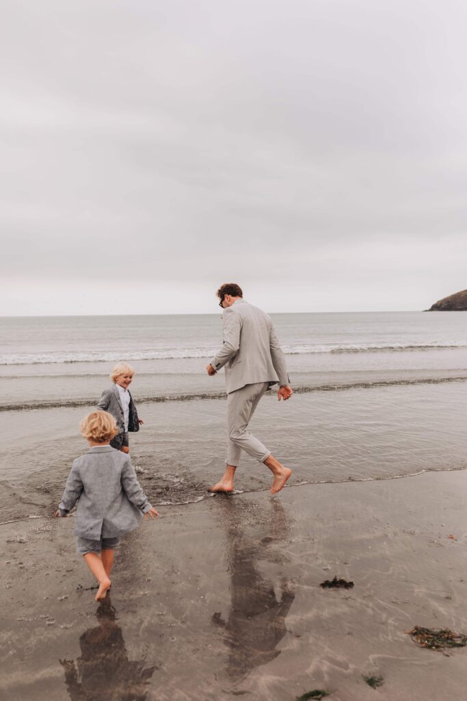 groom running around with two sons on wedding day