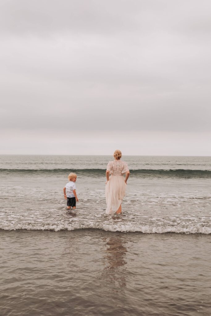 bride and son wave jumping at countryside elopement