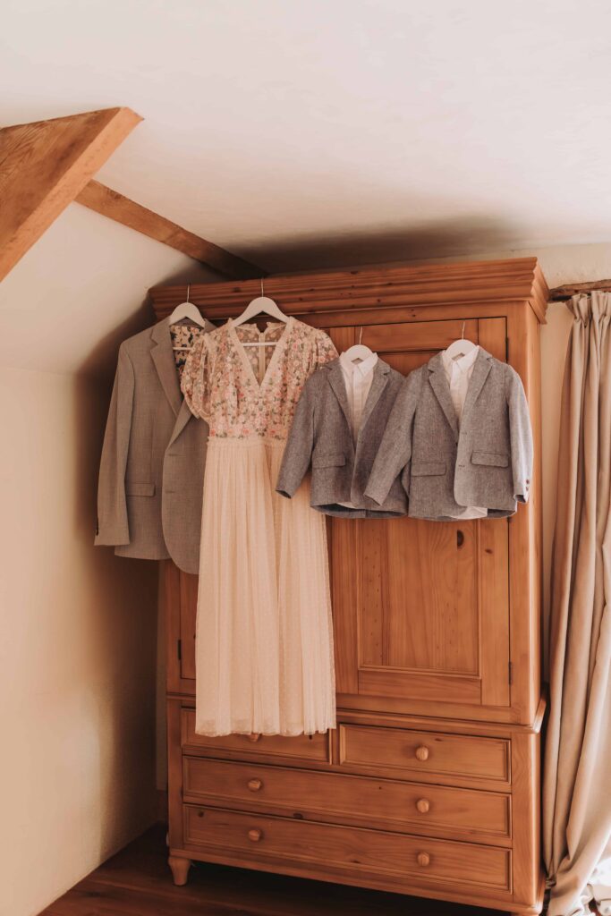 familys outfits hung up for countryside elopement