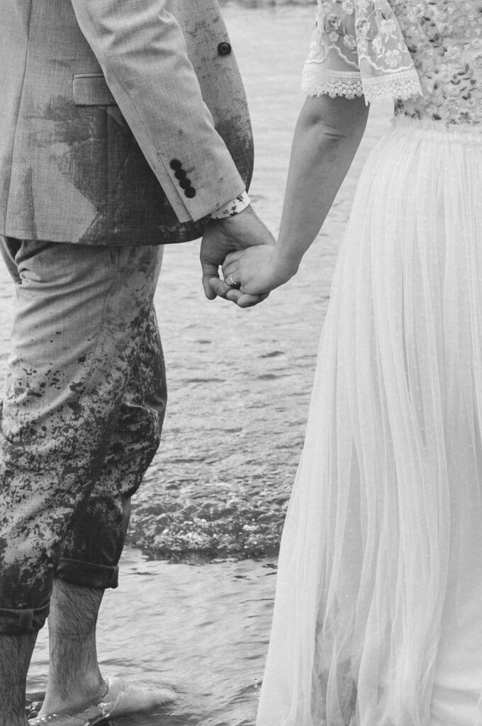 bride and groom holding hands at elopement on beach