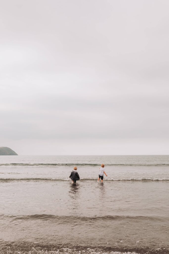 two young boys wave jumping on parents wedding day