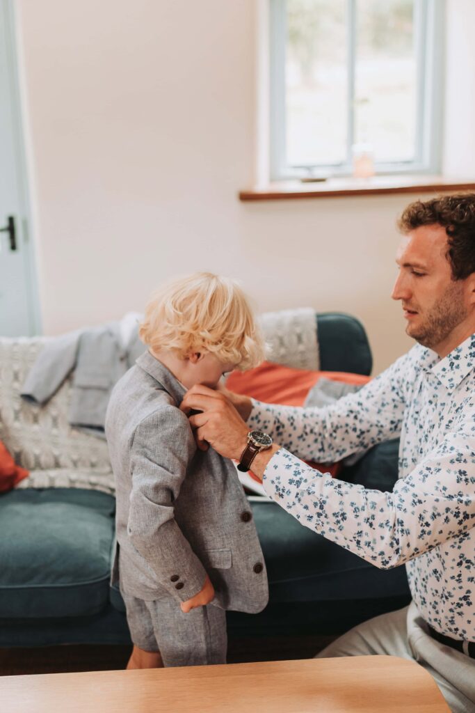 dad putting sons jacket on for elopement