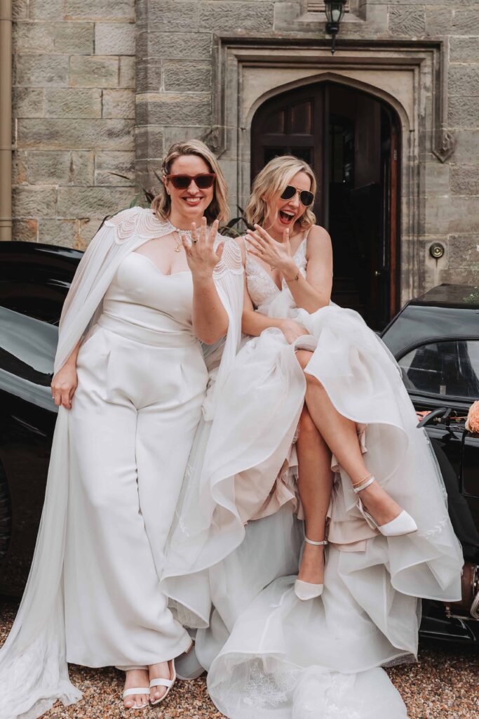 brides showing off new rings with sunglasses on