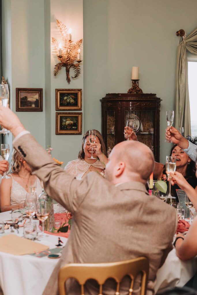 weddings guests cheering glasses during speeches