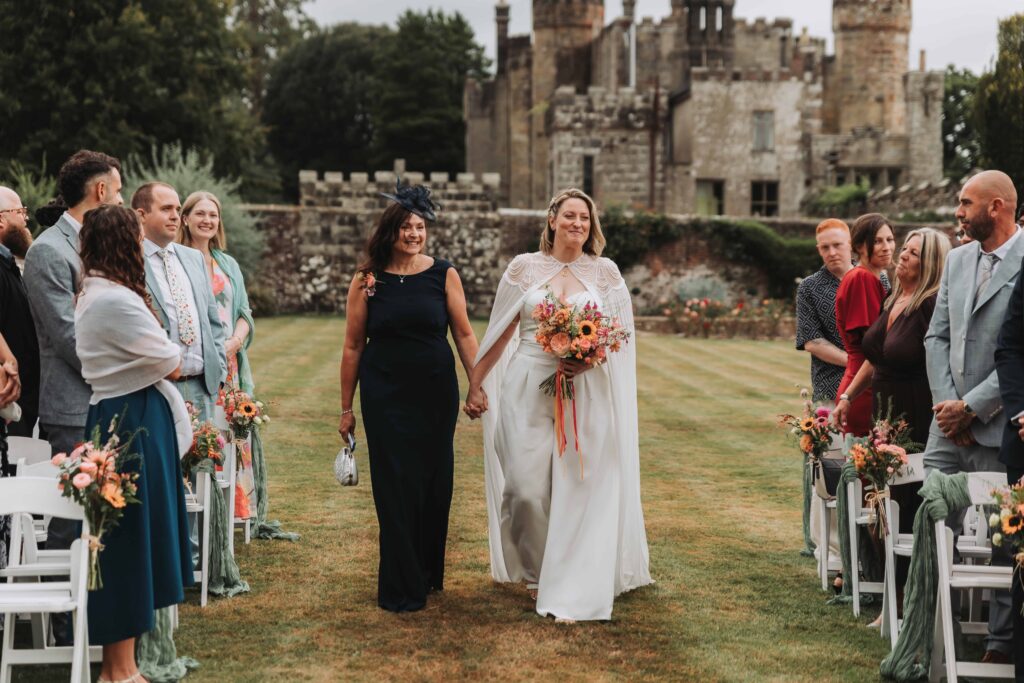 bride and mother of the bride walking down the aisle