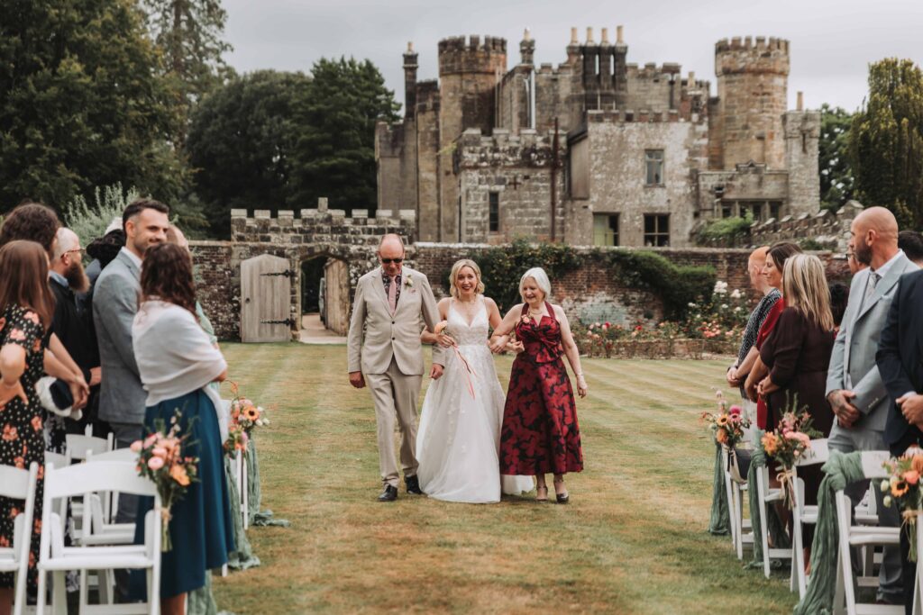bride walking with her parents down the aisle
