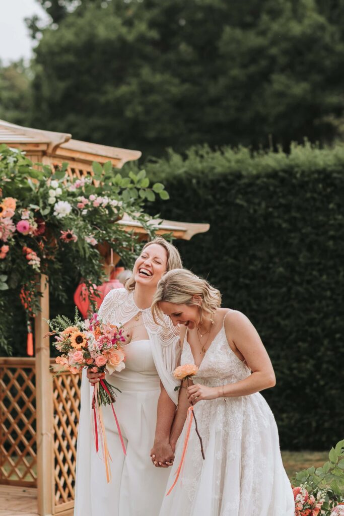 brides laughing at wadhurst castle wedding ceremony