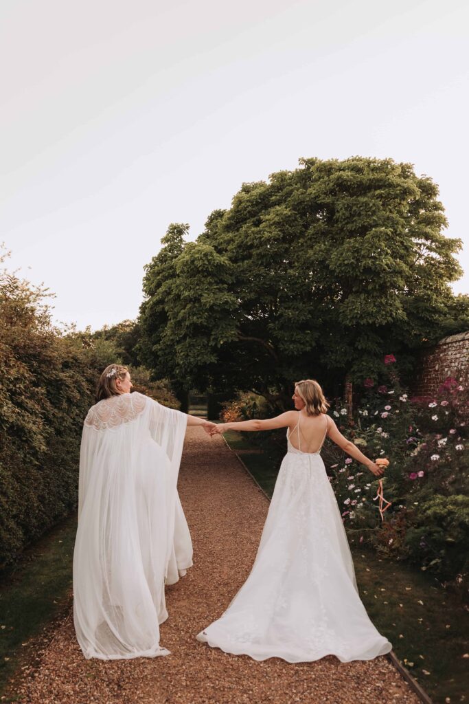 two brides walking holding hands