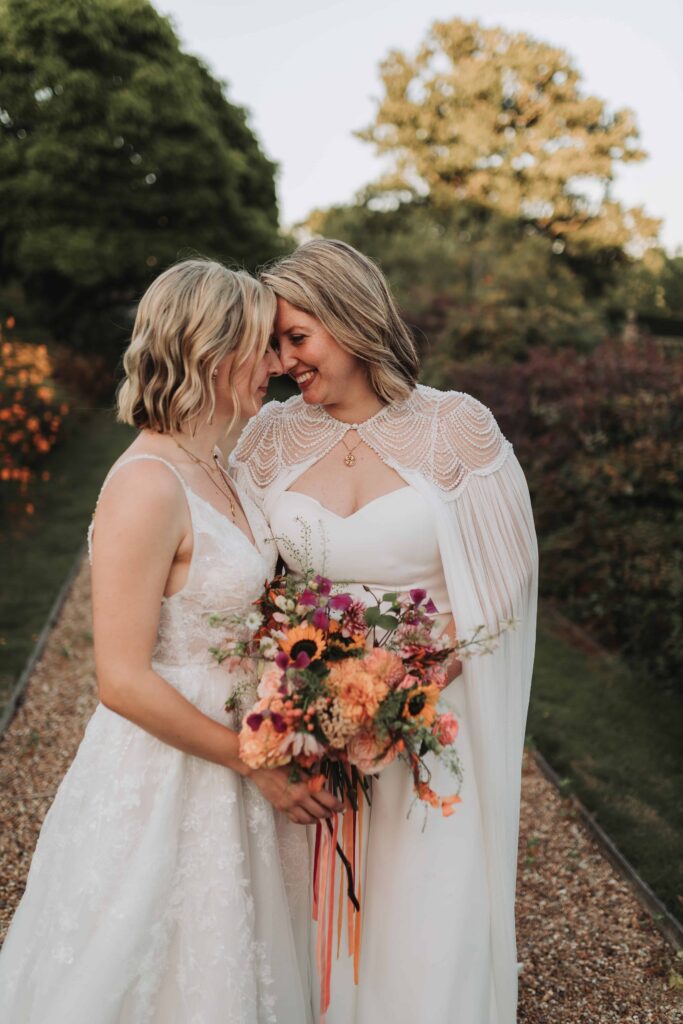 two brides holding eachother at lgbtq wedding