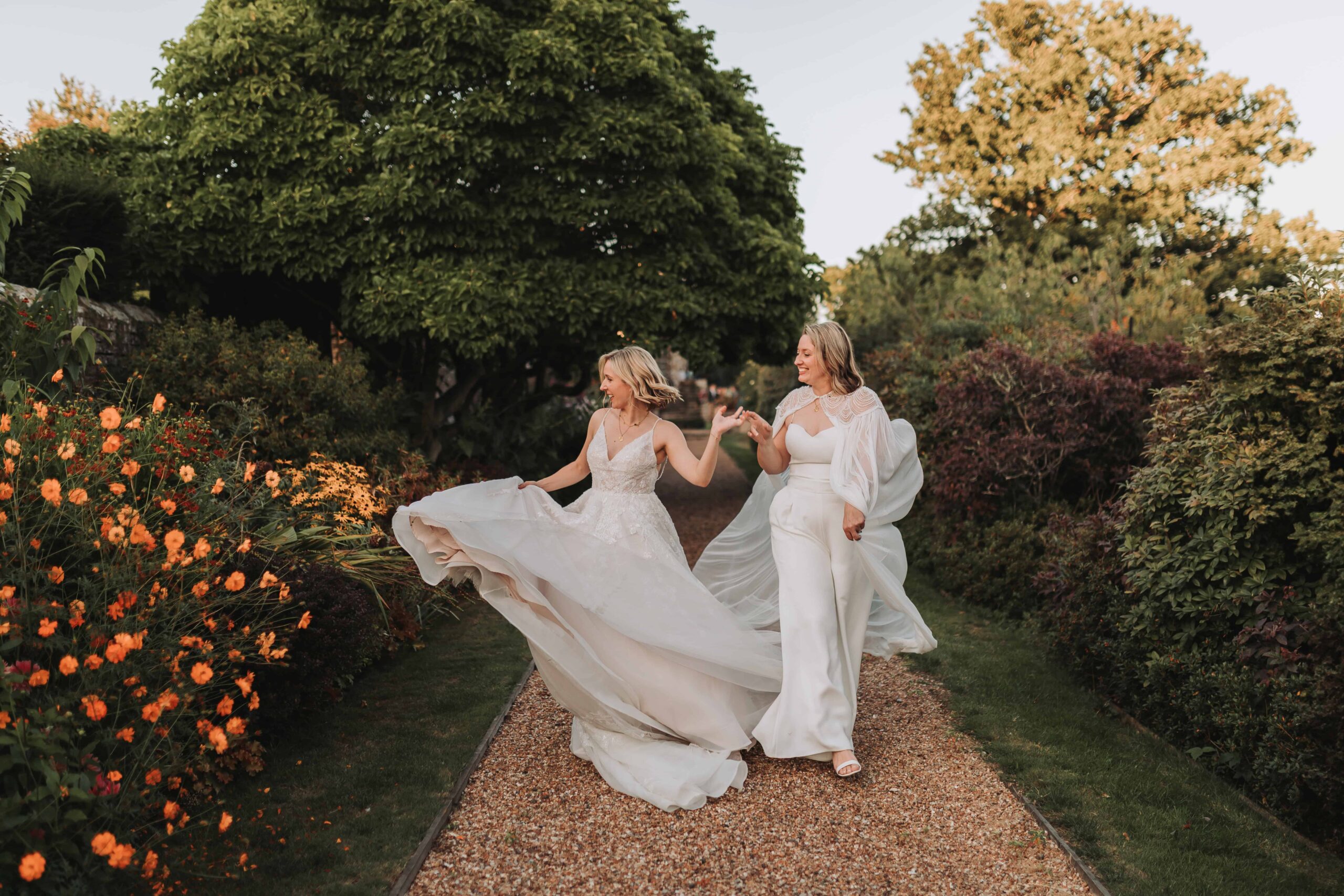 brides spinning each other around at lgbtq wedding