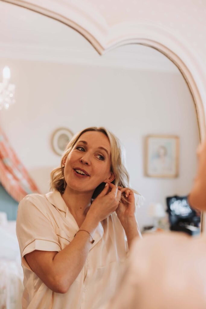 bride putting earrings in