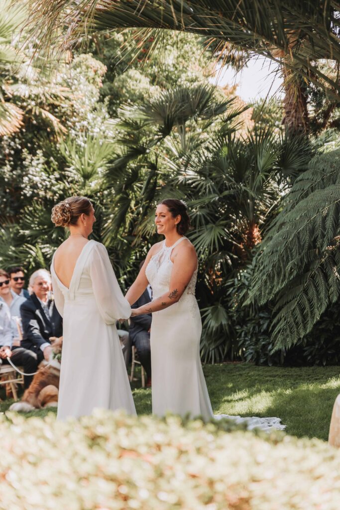 brides holding hands at wedding ceremony