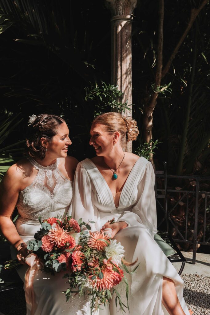 two brides looking at eachother and smiling