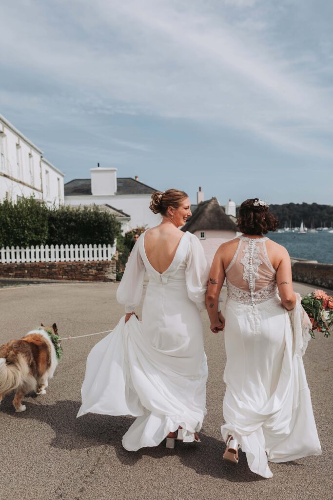 brides walking their dog down the hill