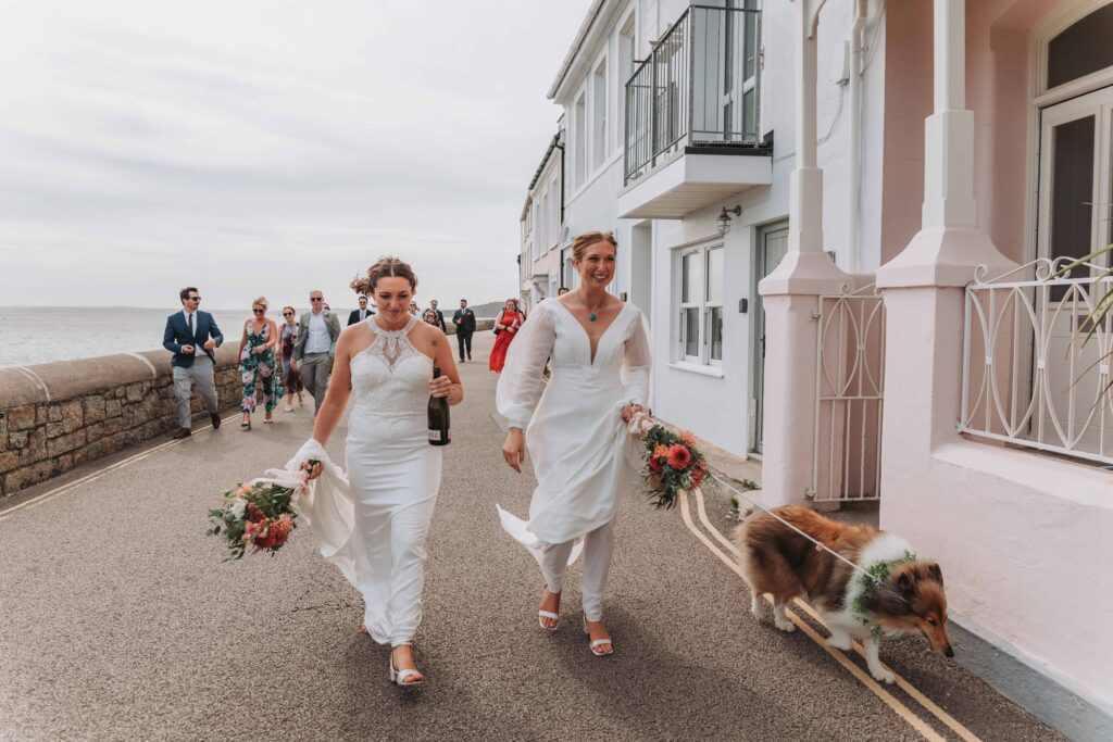 brides leading guests walking through st mawes