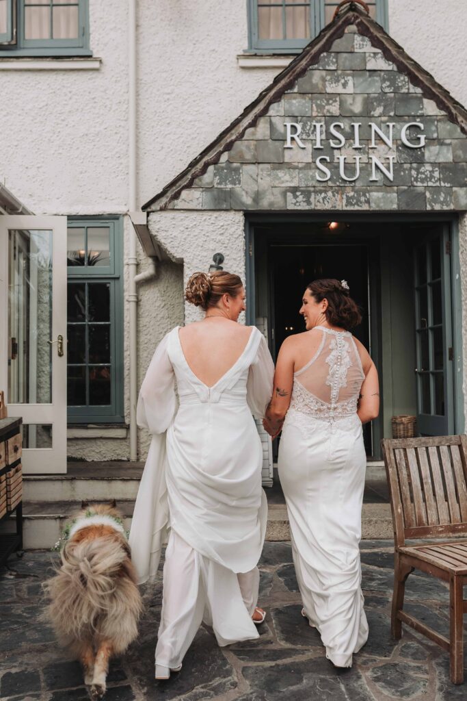 two brides walking in the riding sun st mawes