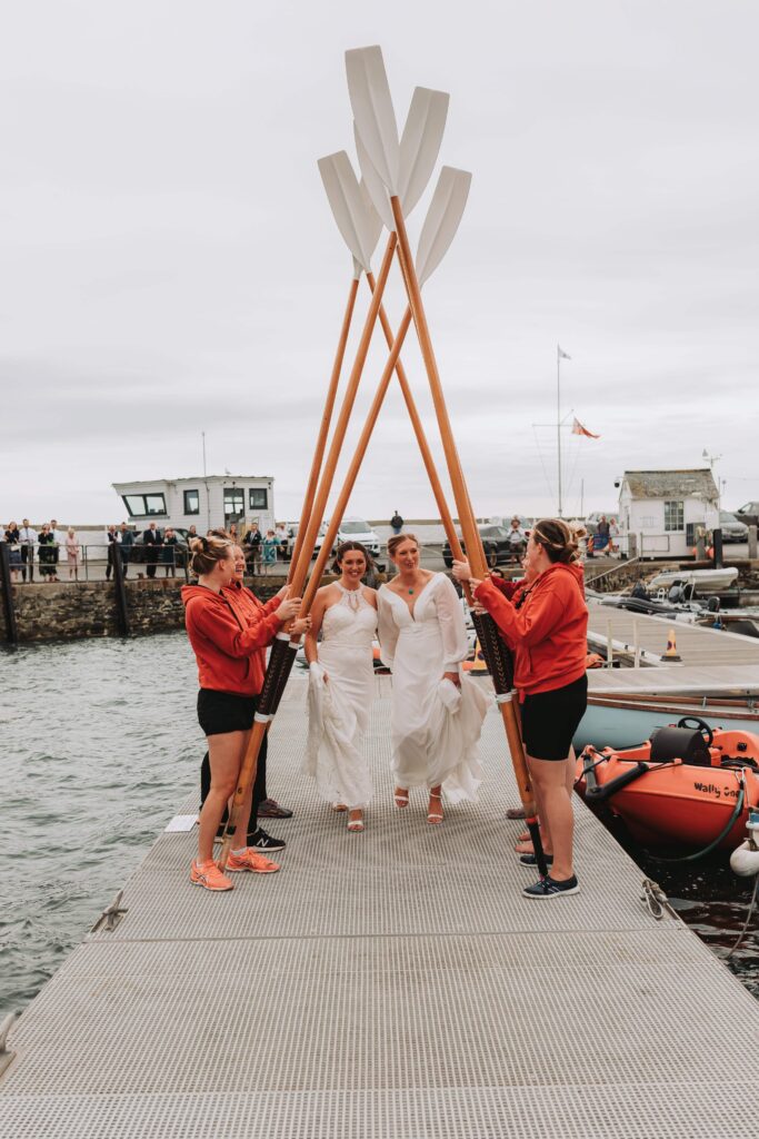 two brides walking under gig oar walkway cornwall lgbtq+ wedding