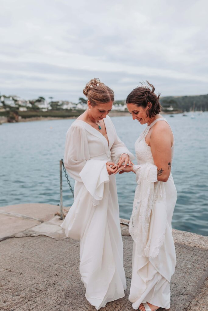 brides touching hands in harbour