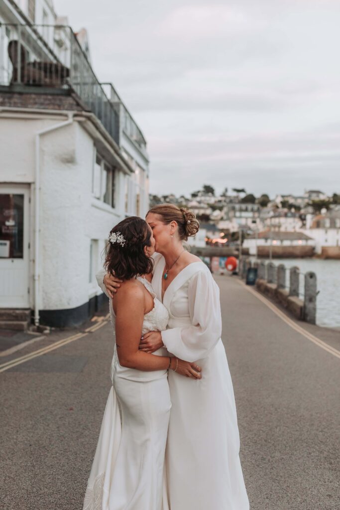 brides kissing in road in st mawes