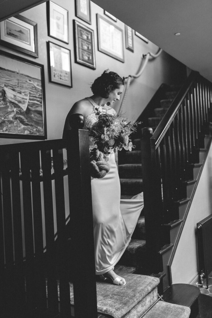 bride coming down the stairs at cornwall lgbtq+ wedding