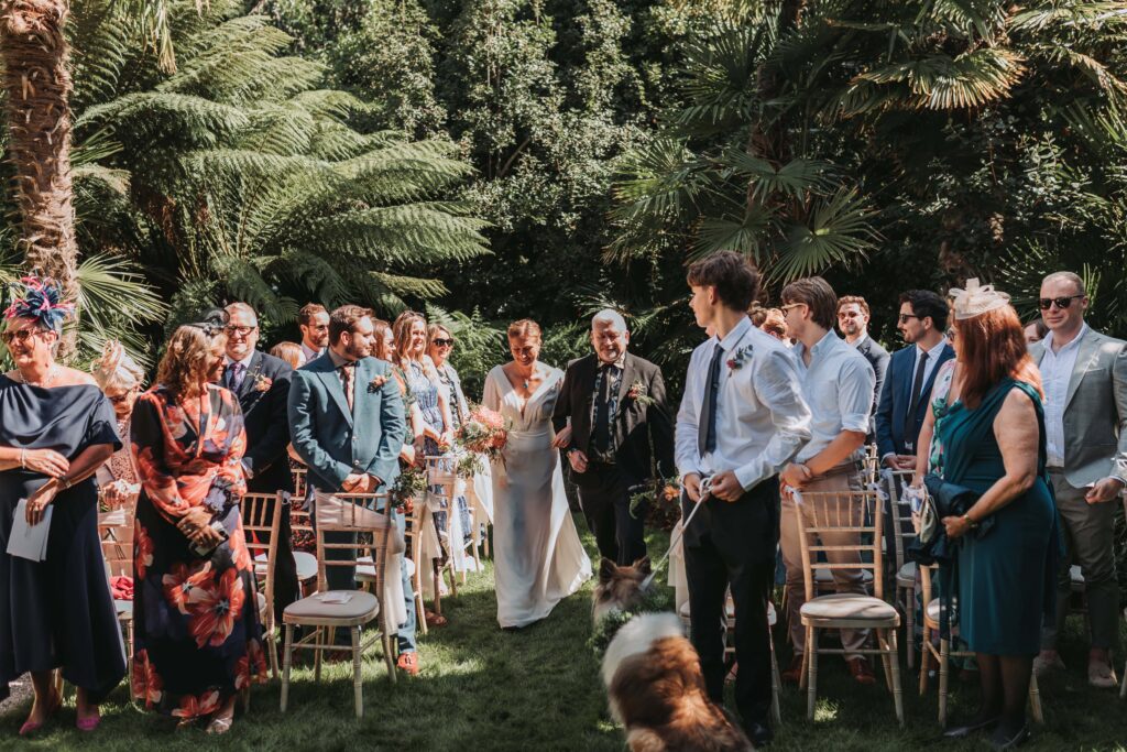 bride and dad walking down the aisle at cornwall lgbtq+ wedding