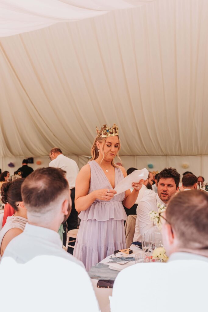bridesmaid reading at wedding breakfast table