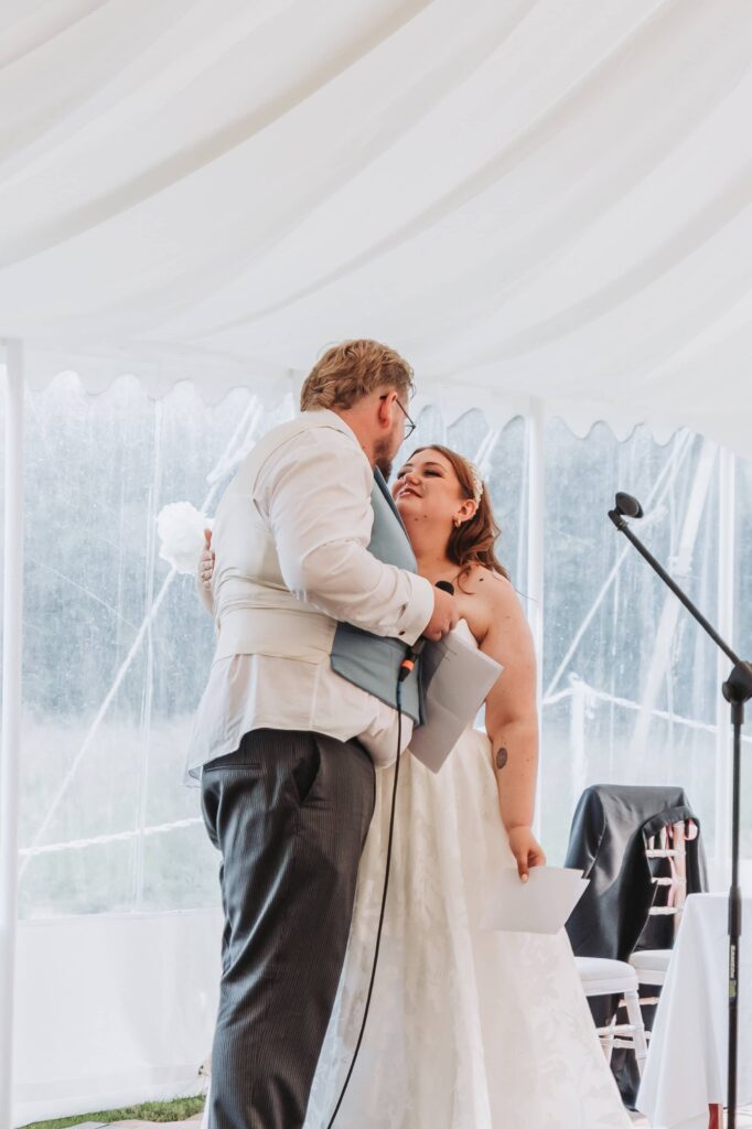 bride and groom doing speech at summer wedding