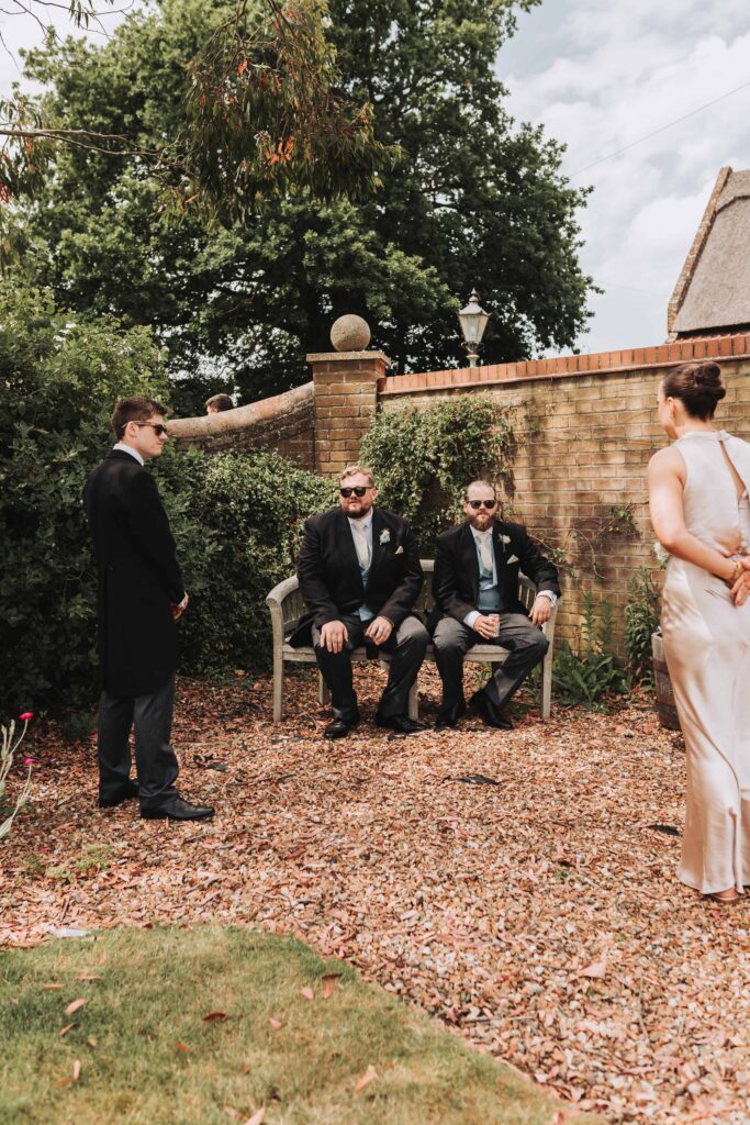 groom and bestman sitting on a bench together