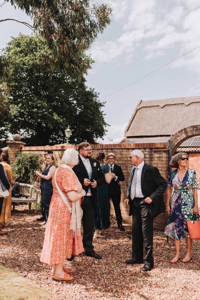 groom greeting guests before ceremony