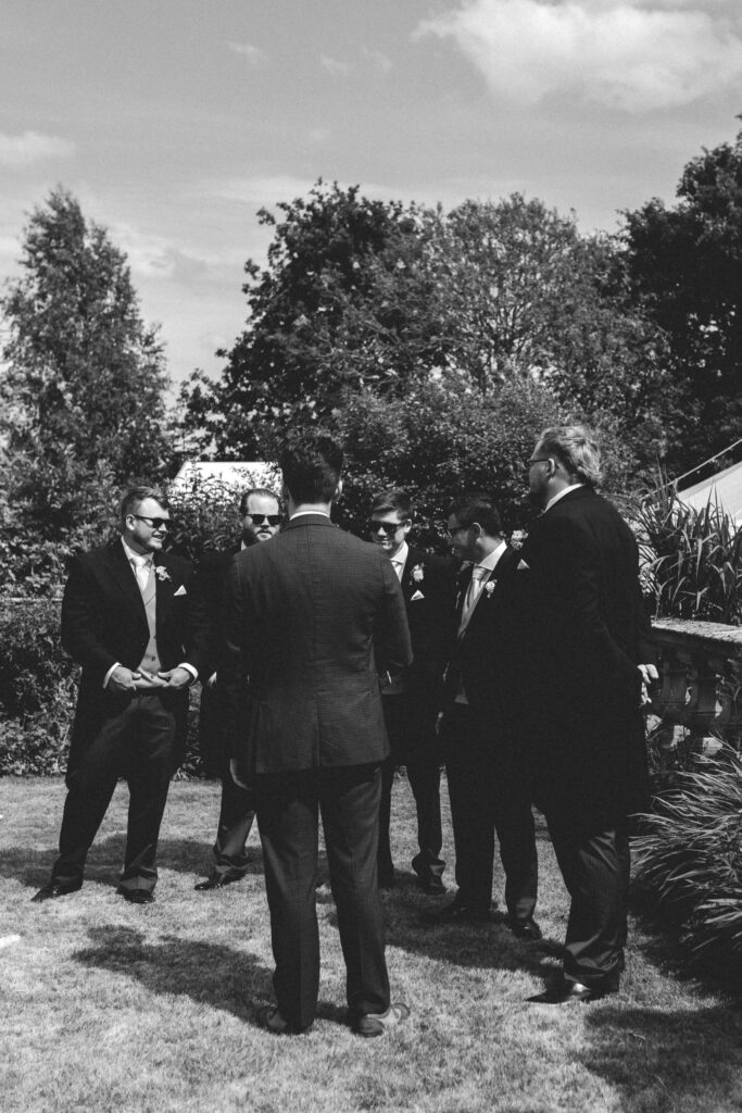groom and groomsman waiting at the front of the aisle