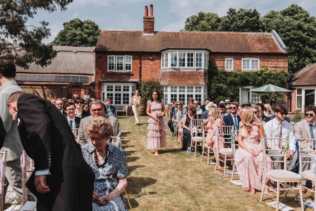 bridal party walking down the aisle at norfolk garden wedding