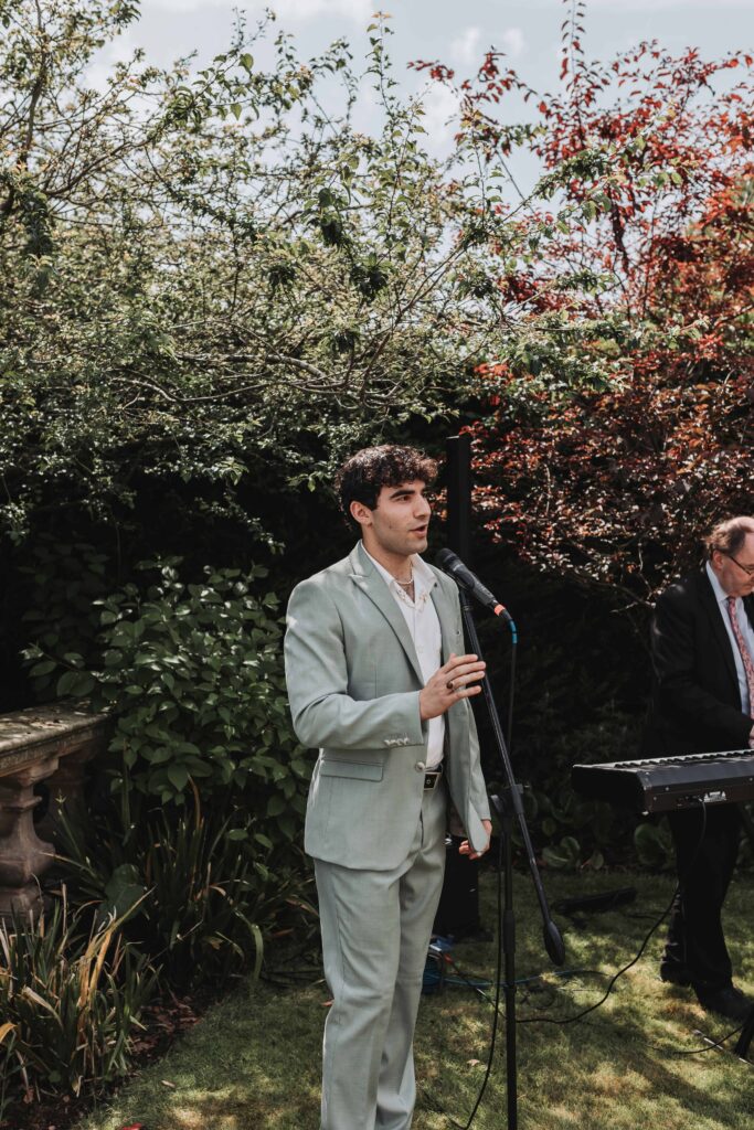 bridesman singing at norfolk garden wedding