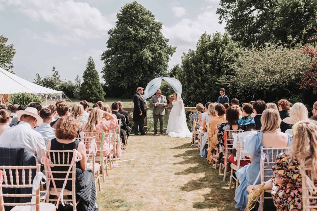 father of the bride reading a poem at the top of the aisle