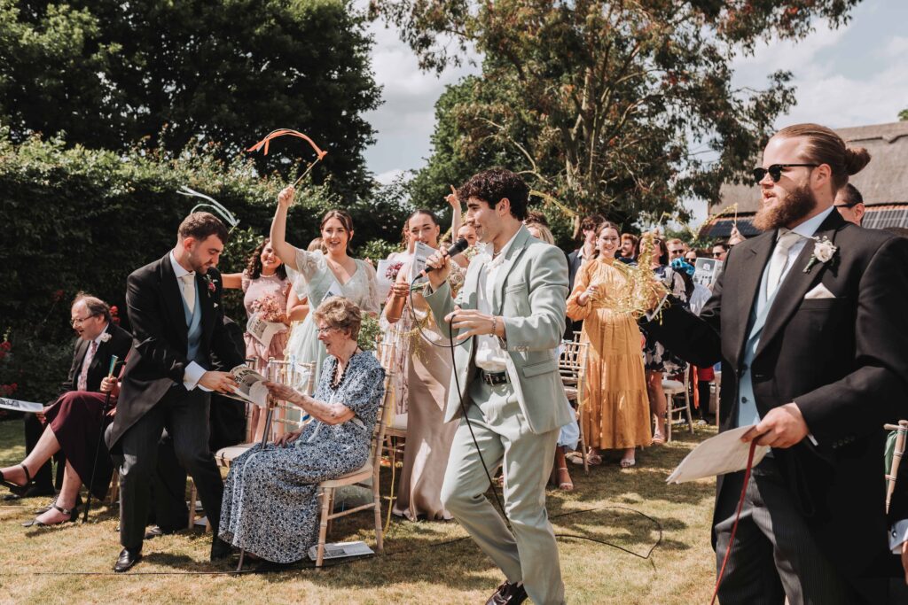 bridesman leading a sing a long during the ceremony