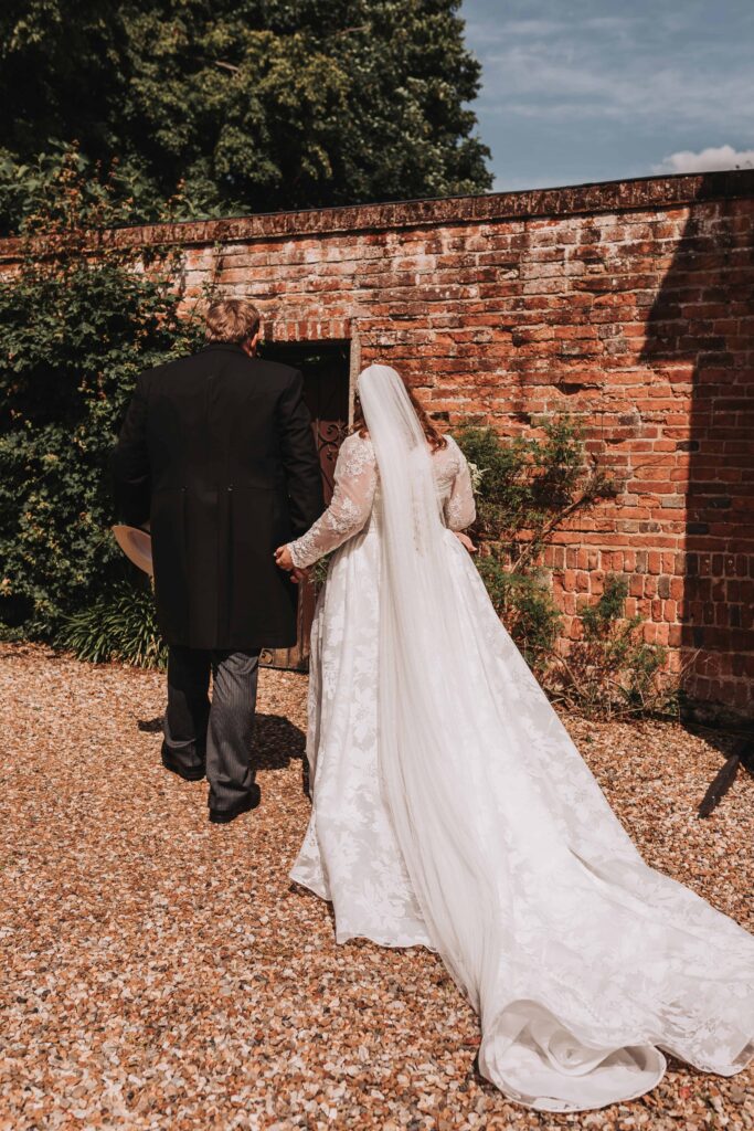 bride and groom walking away at garden wedding
