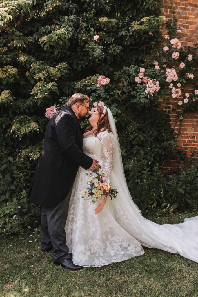 bride and groom holding eachother at norfolk garden wedding