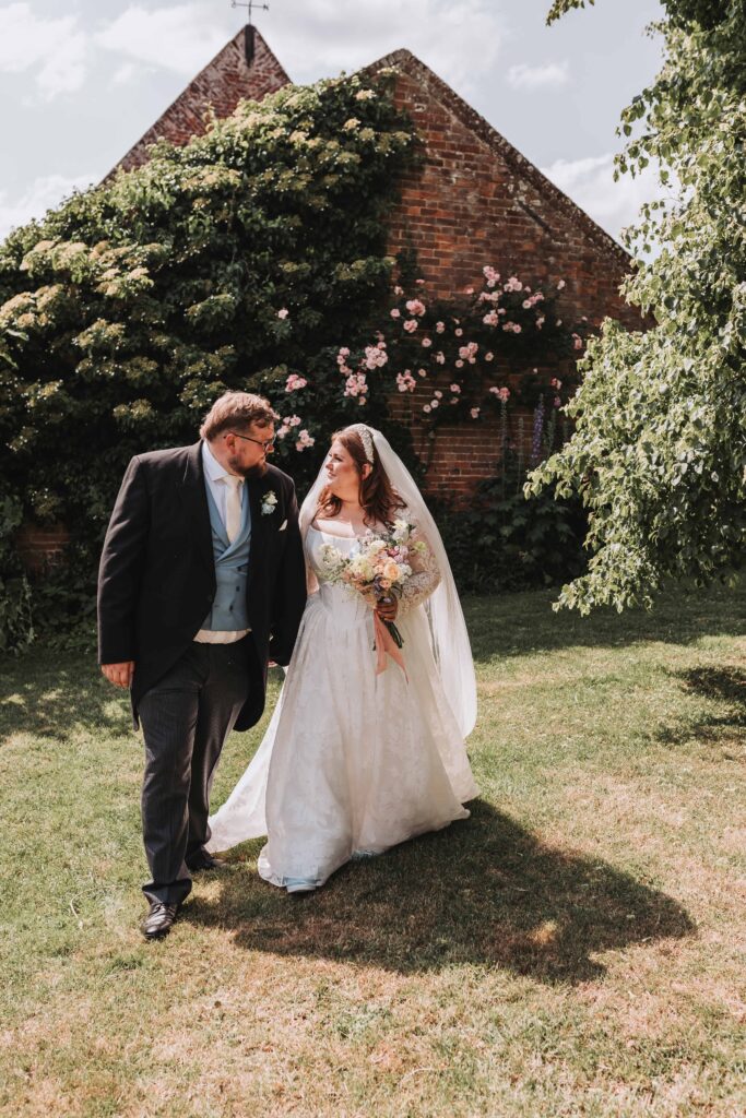 bride and groom smiling at eachother on wedding day