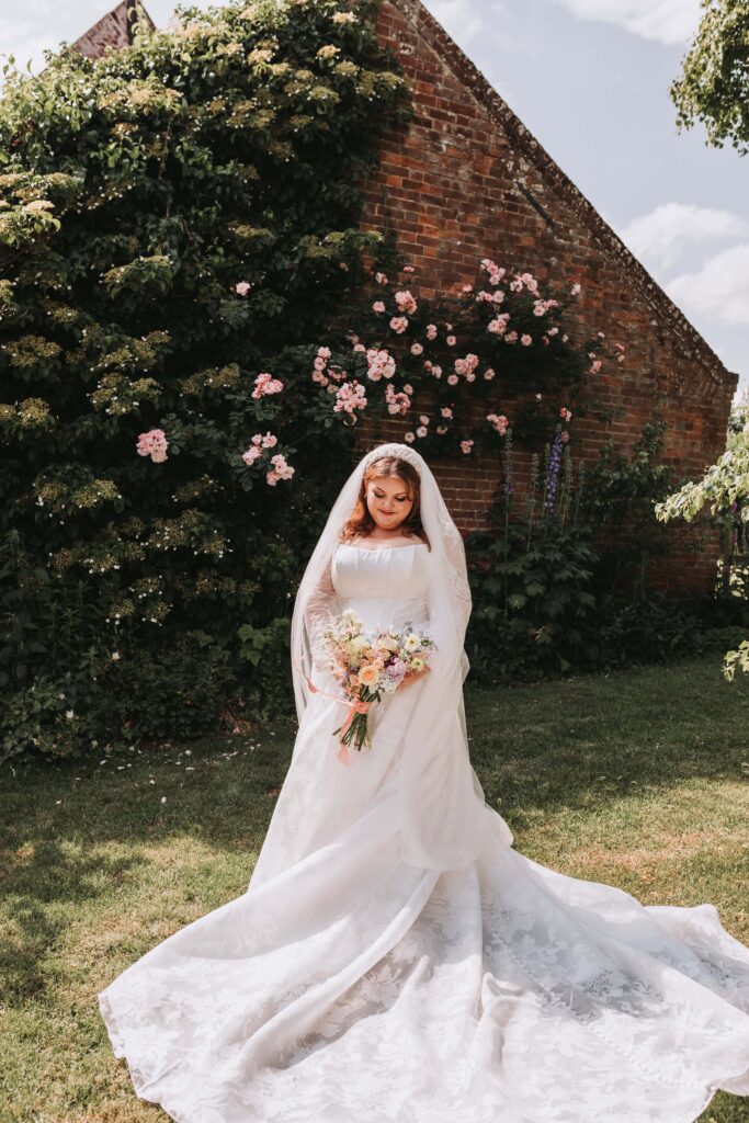 bride on her own looking down at her flowers