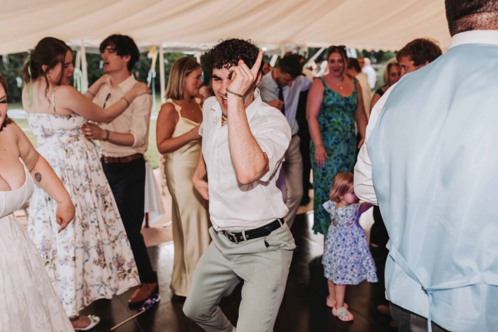 bridesman dancing at summer wedding