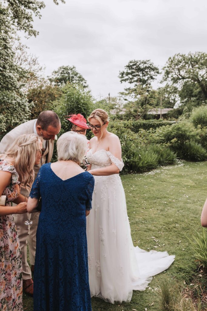 bride showing her ring to her family
