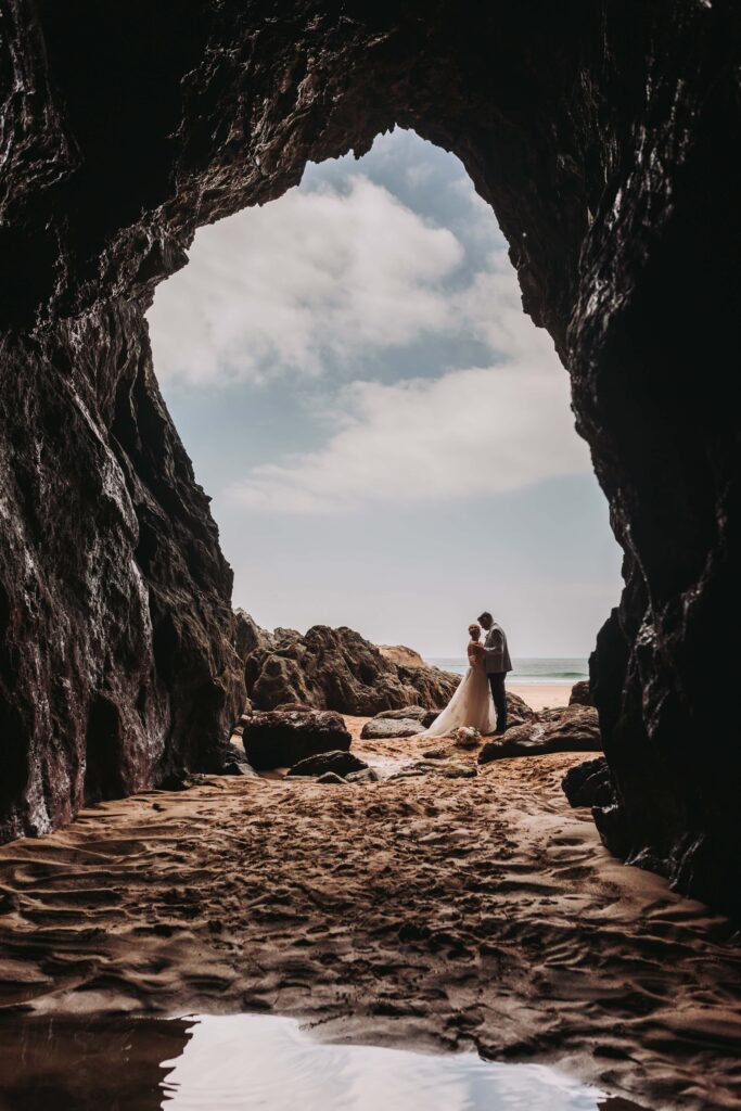 photo of bride and groom from inside a cave