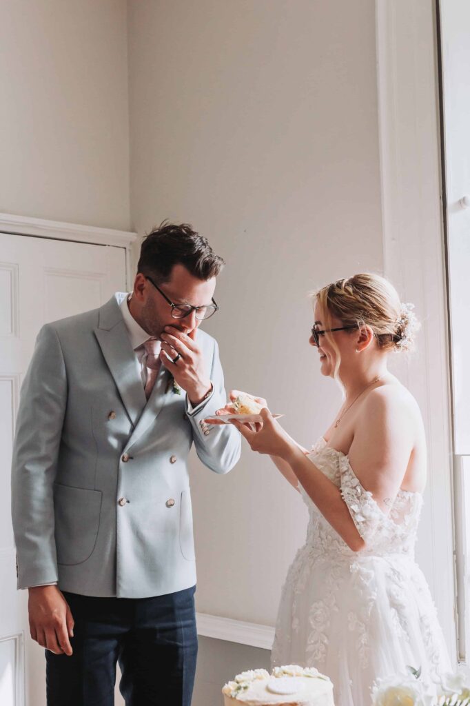 first taste of wedding cake at treseren wedding